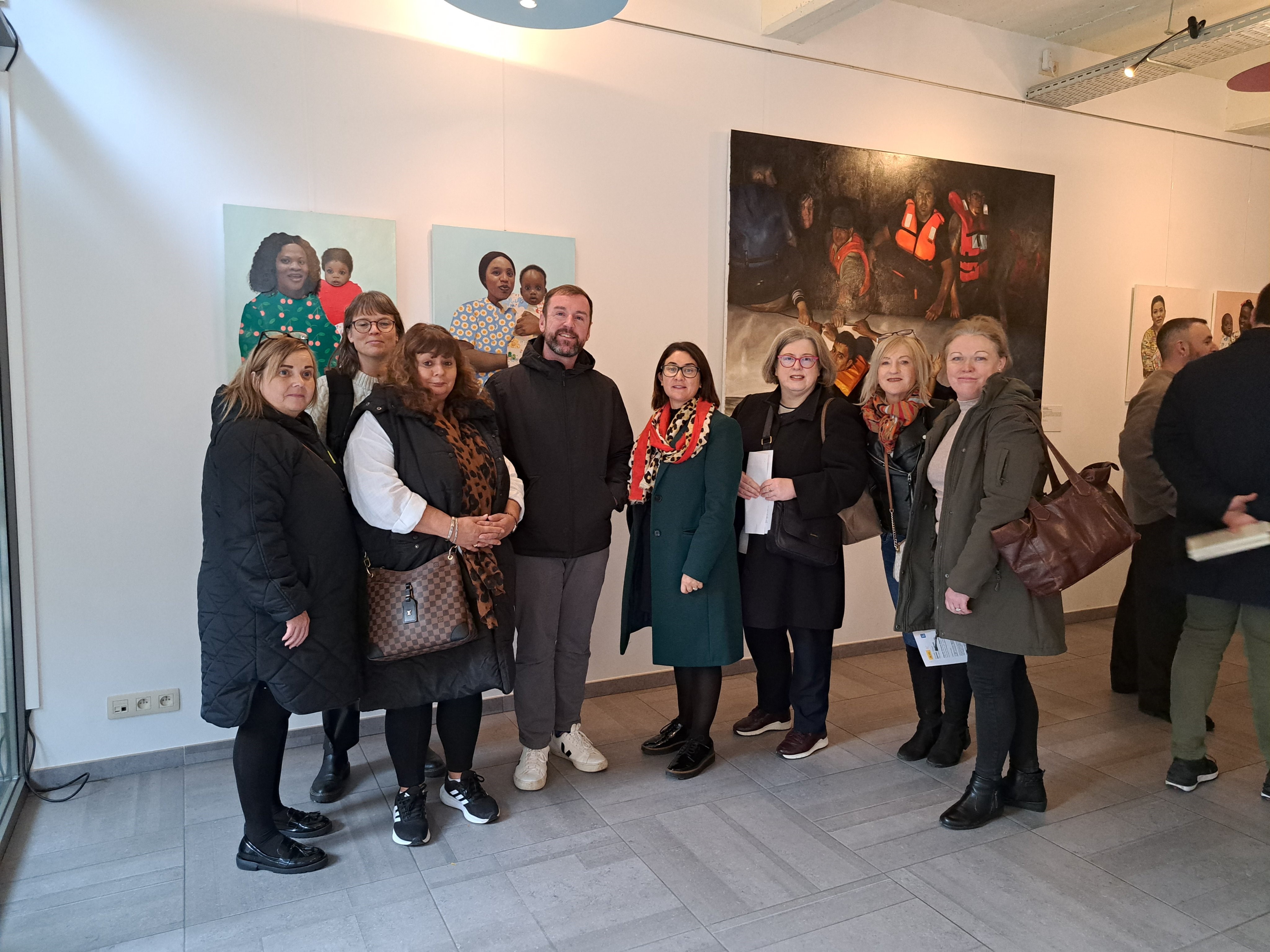 Community education network members stand together at art exhibition